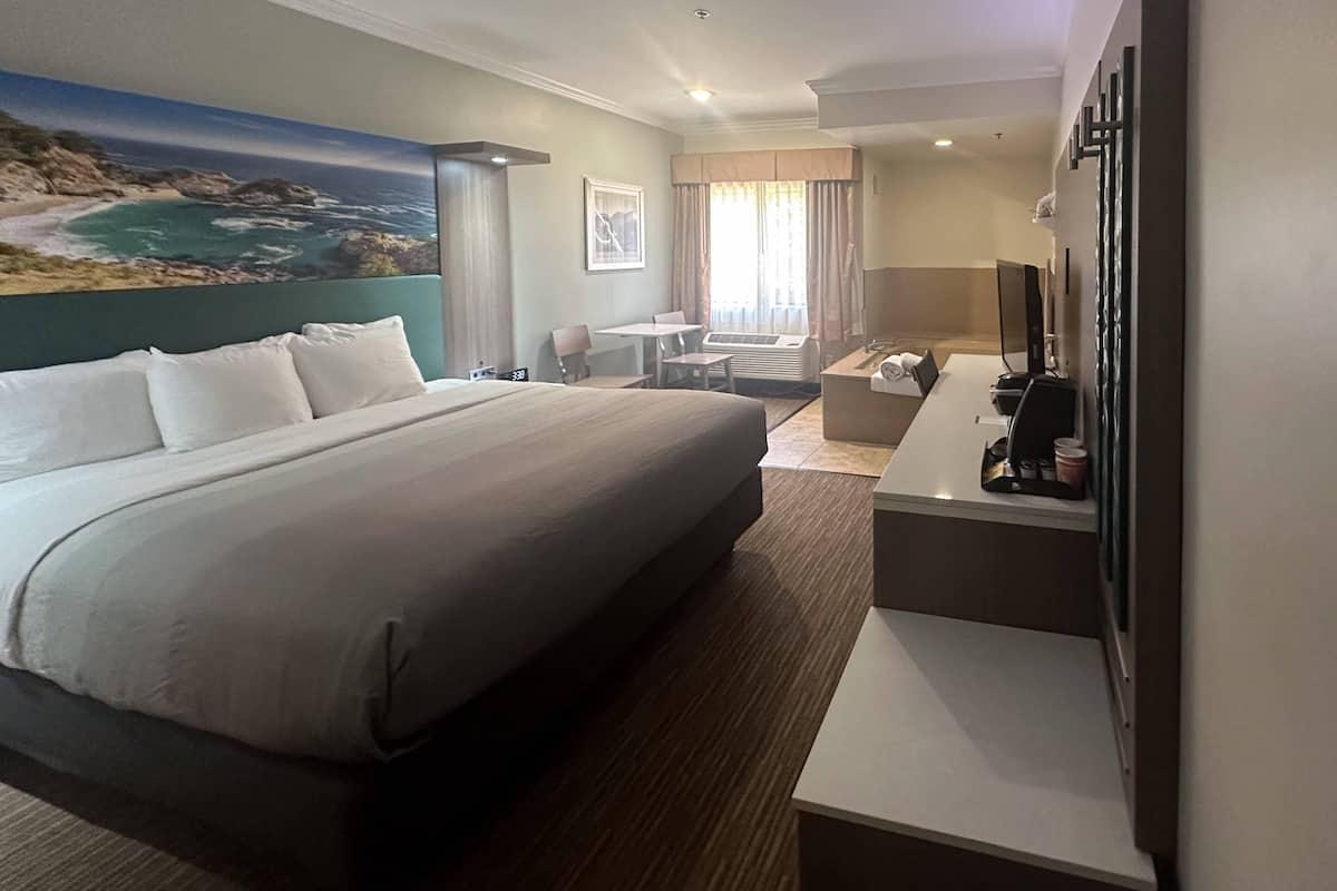 Deluxe Room, 1 King Bed, In-Room Jetted Tub, Non Smoking | In-room safe, desk, laptop workspace, blackout curtains