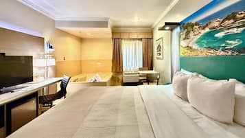 Deluxe Room, 1 King Bed, In-Room Jetted Tub, Non Smoking | In-room safe, desk, laptop workspace, blackout drapes
