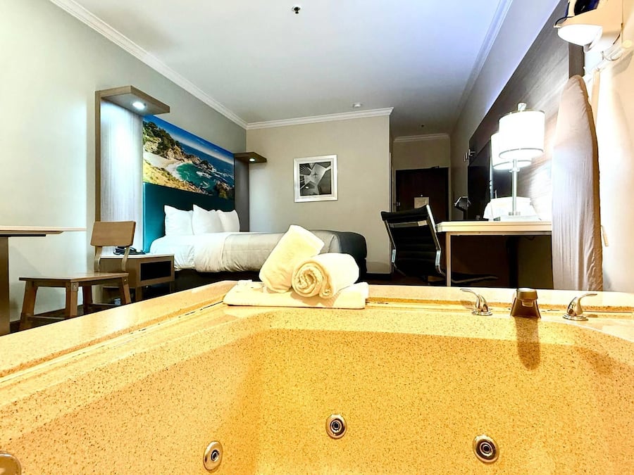 Deluxe Room, 1 King Bed, In-Room Jetted Tub, Non Smoking | In-room safe, desk, laptop workspace, blackout drapes