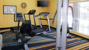 A fitness room with treadmills, a stationary bike, and a weight machine. - Quality Inn Albertville US 431 (Albertville)