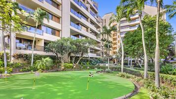 Play a round of mini-golf amidst lush tropical plants and neatly trimmed hedges.