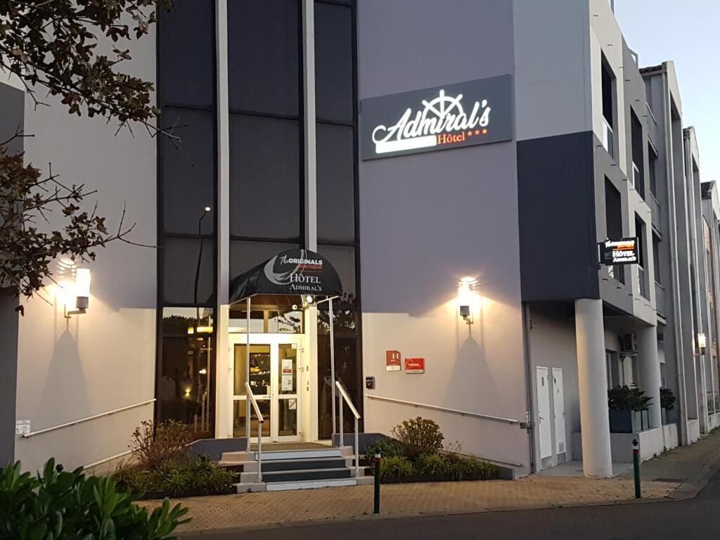 A hotel entrance with a sign reading "Admiral's Hotel".