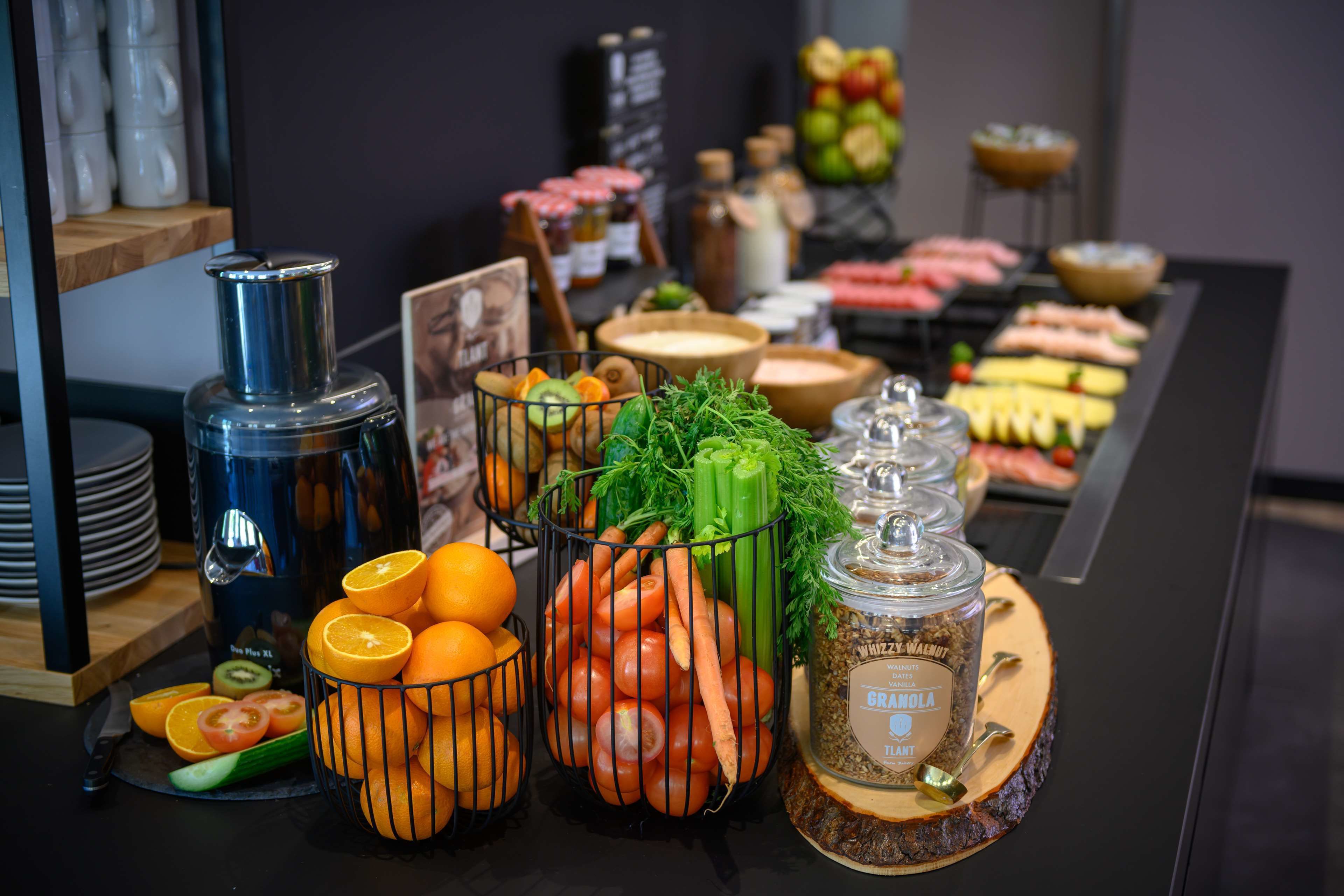 A buffet table with various food items and condiments.