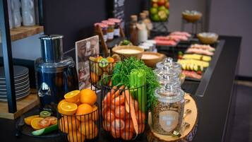 A buffet table with various food items and condiments.