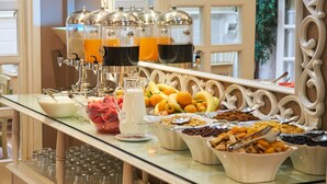 A buffet with various food items and beverage dispensers.