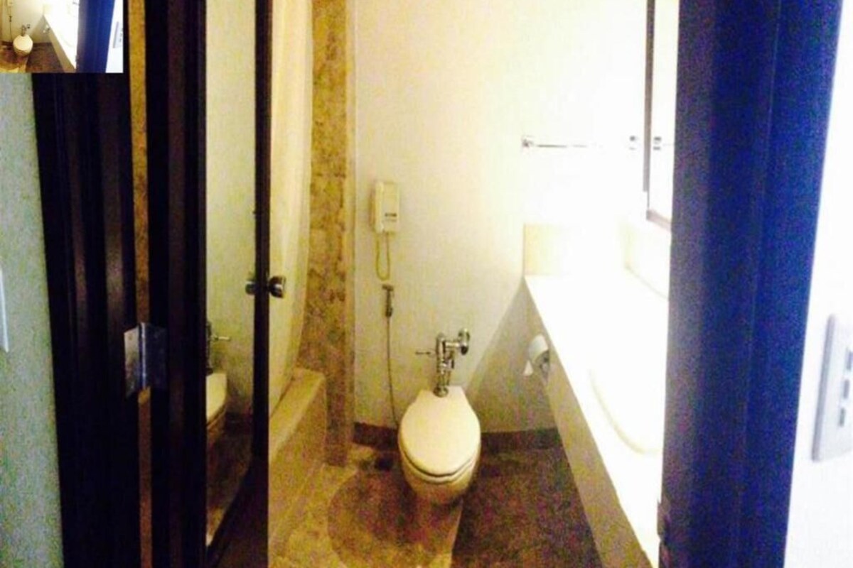 A bathroom with a toilet, a shower, and a bathtub.