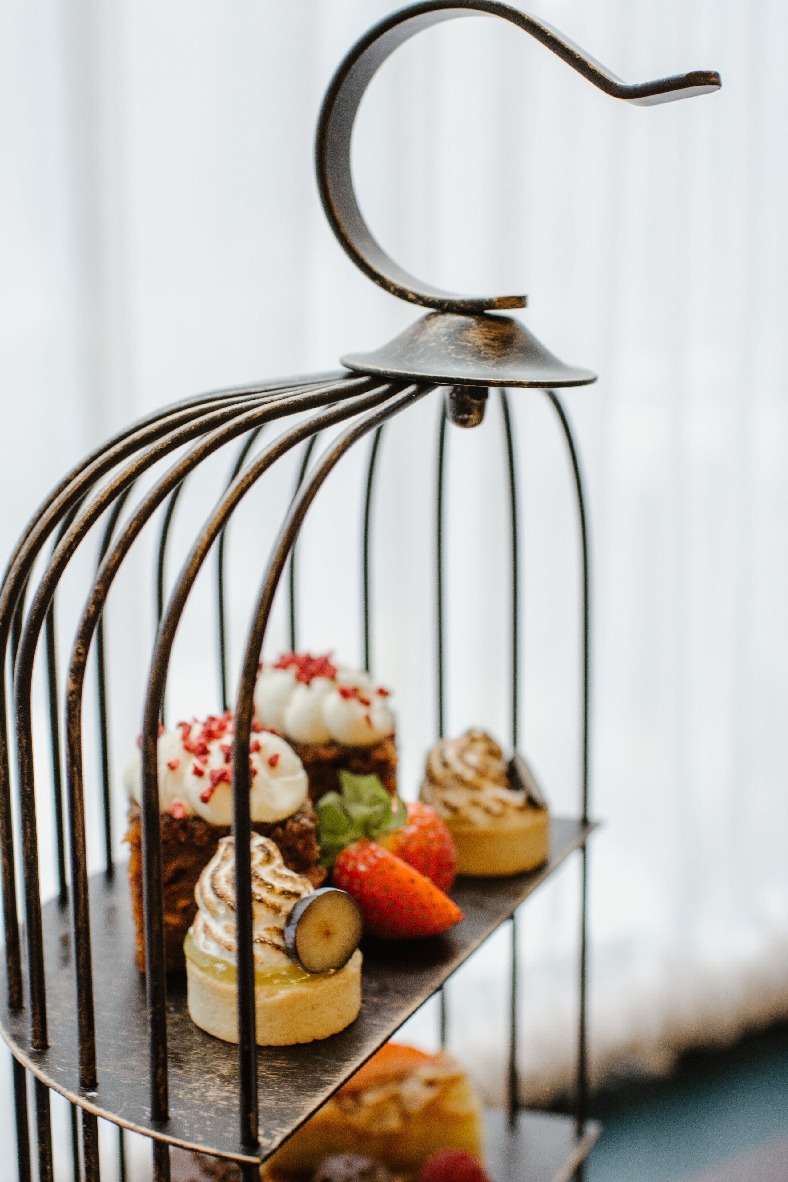 A metal dessert stand with various pastries.