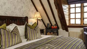 Une chambre avec un lit, une table de chevet, une lampe et une fenêtre.