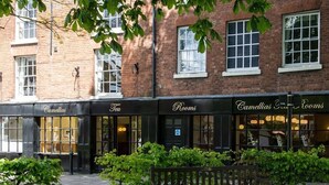A row of storefronts with signs for "Camellias Tea," "Rooms," and "Camellias Tea Rooms." - Prince Rupert Hotel (Shrewsbury)