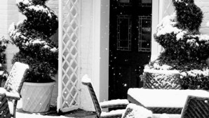 A gazebo with a lattice door, surrounded by snow-covered potted plants and outdoor furniture. - Prince Rupert Hotel (Shrewsbury)