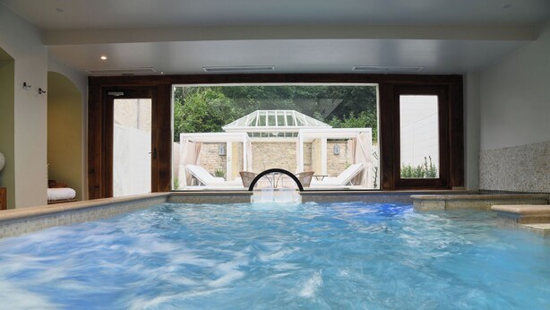 A hot tub with a view of a building through open doors. - Montigo Resorts, Somerset (Shepton Mallet)