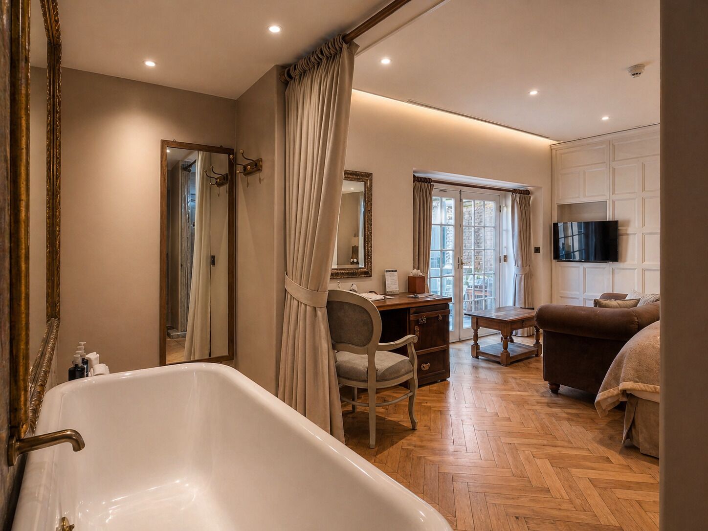 A bathroom with a bathtub, a mirror, and a shower curtain.