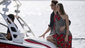 A couple on a boat with a view of the water.