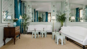 A room with a white sofa, matching side tables, a wooden dresser, and a large mirror. - Room Mate Collection Isabella, Florence (Florence)