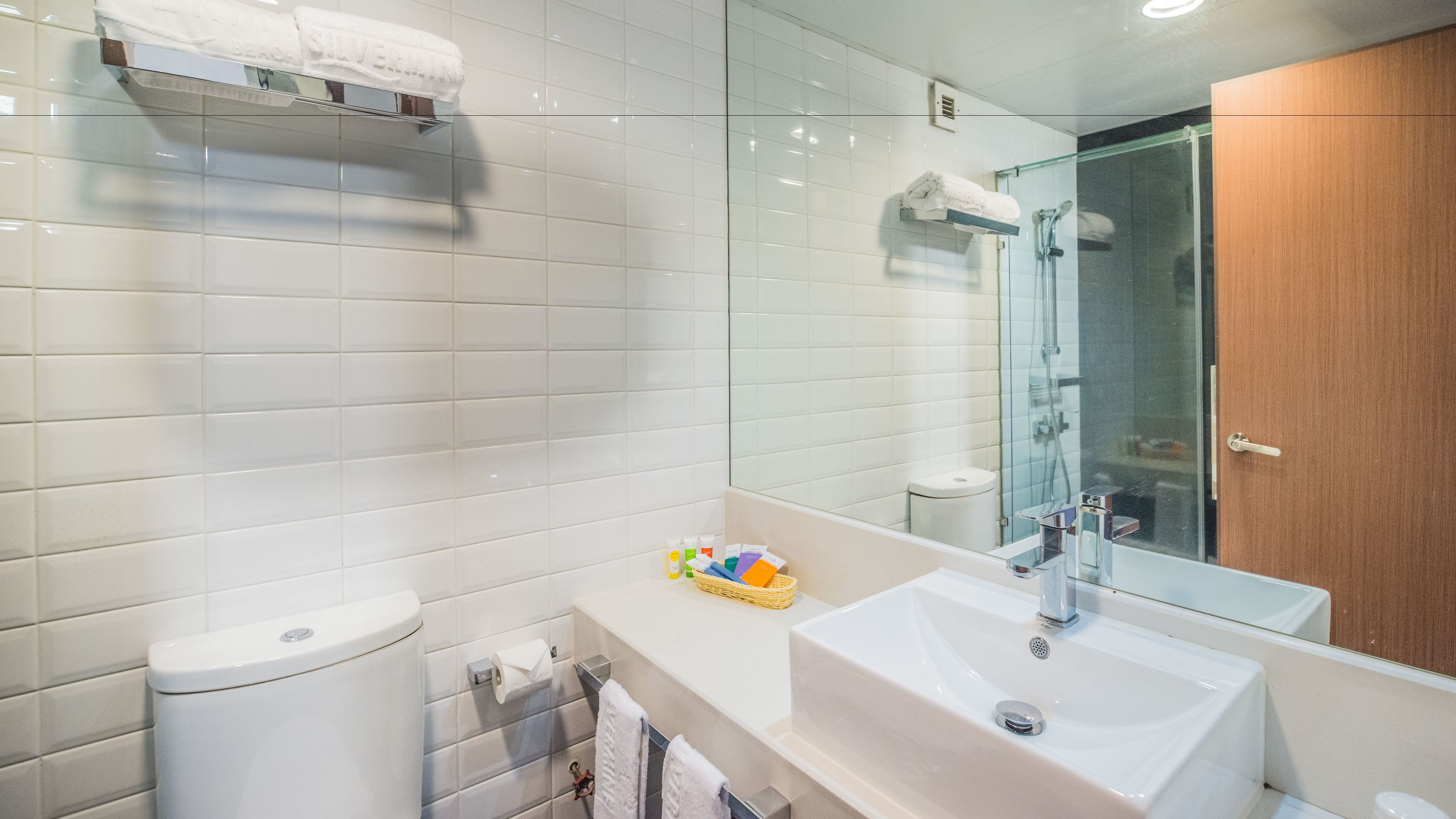 shower, hair dryer, slippers, towels