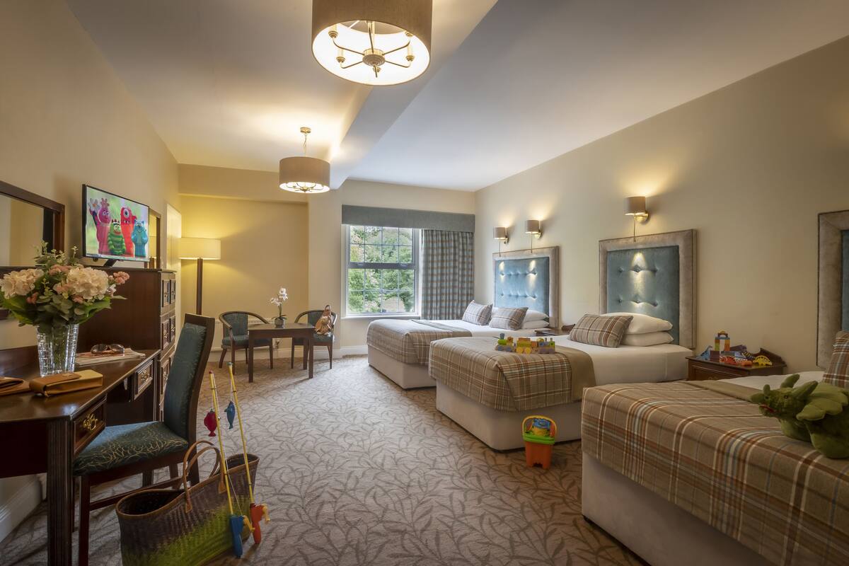 family room, multiple beds | in-room safe, desk, iron/ironing board, free wifi