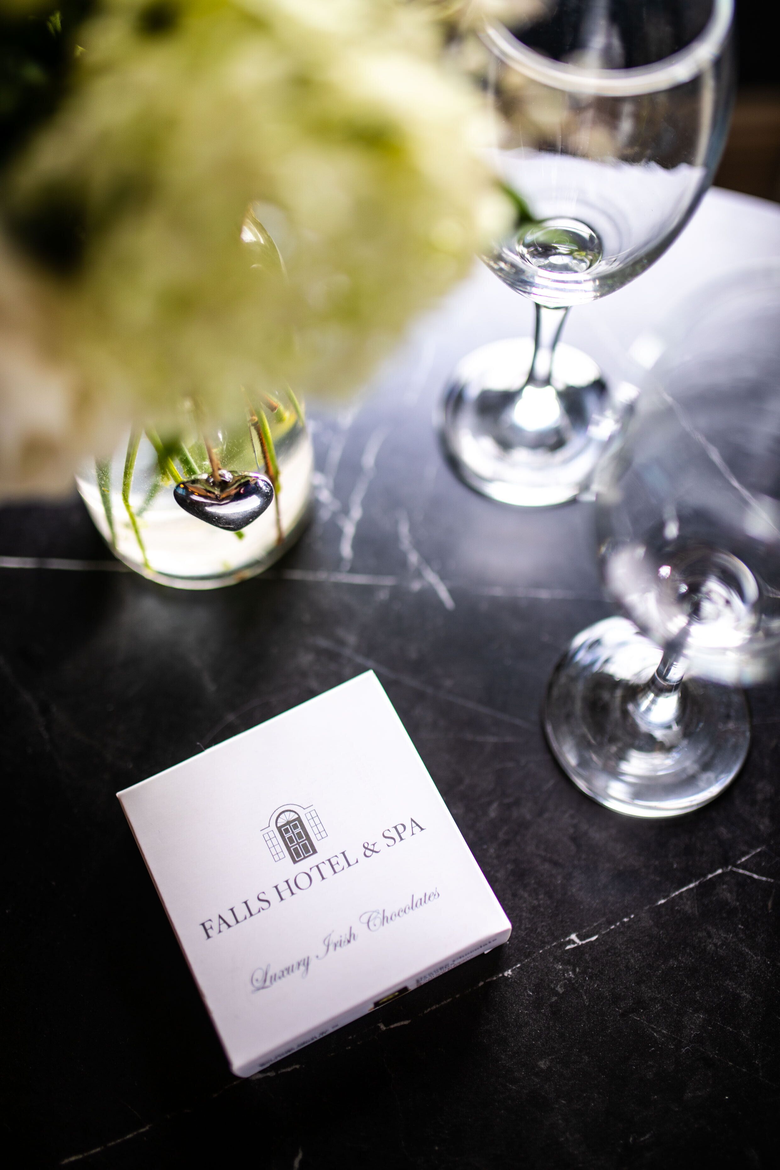 A white box labeled "Falls Hotel & Spa" with "Luxury Irish Chocolates" on a black surface.