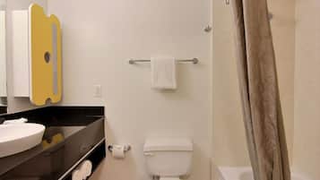 A bathroom with a toilet, a sink, a mirror, and a towel rack.