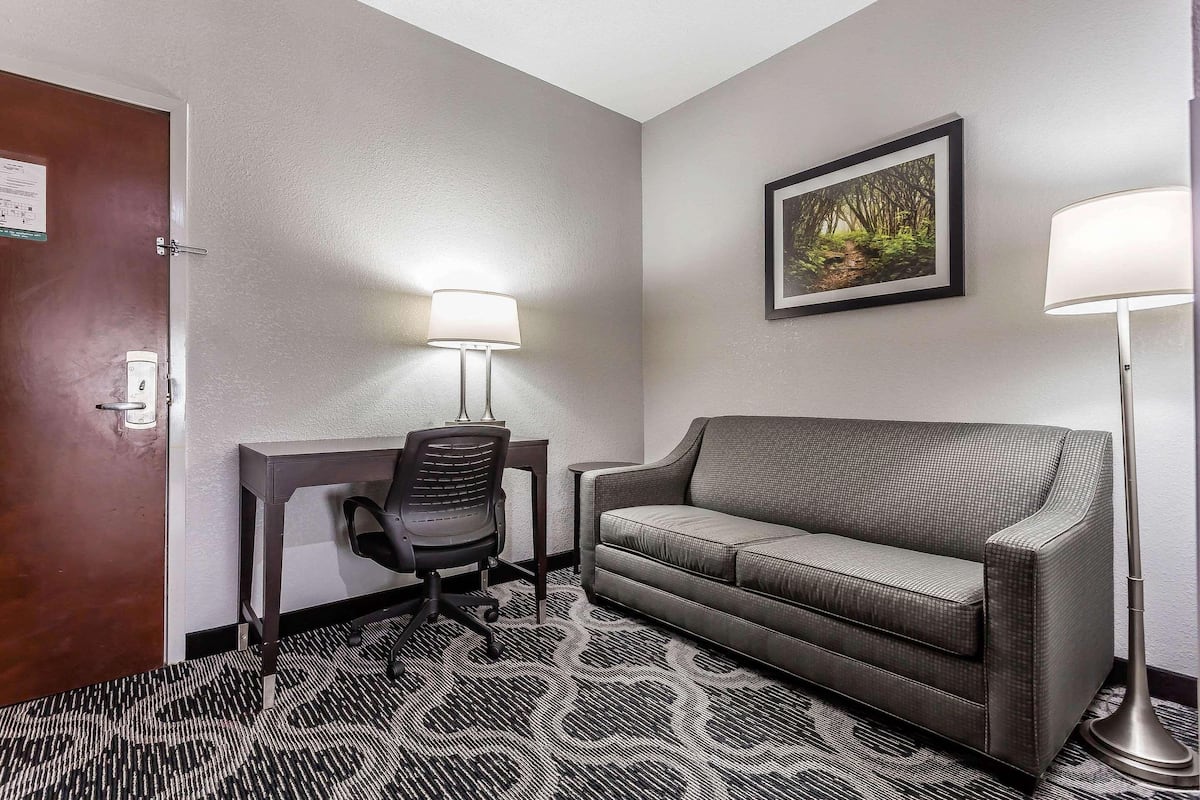 Desk, laptop workspace, blackout drapes, iron/ironing board