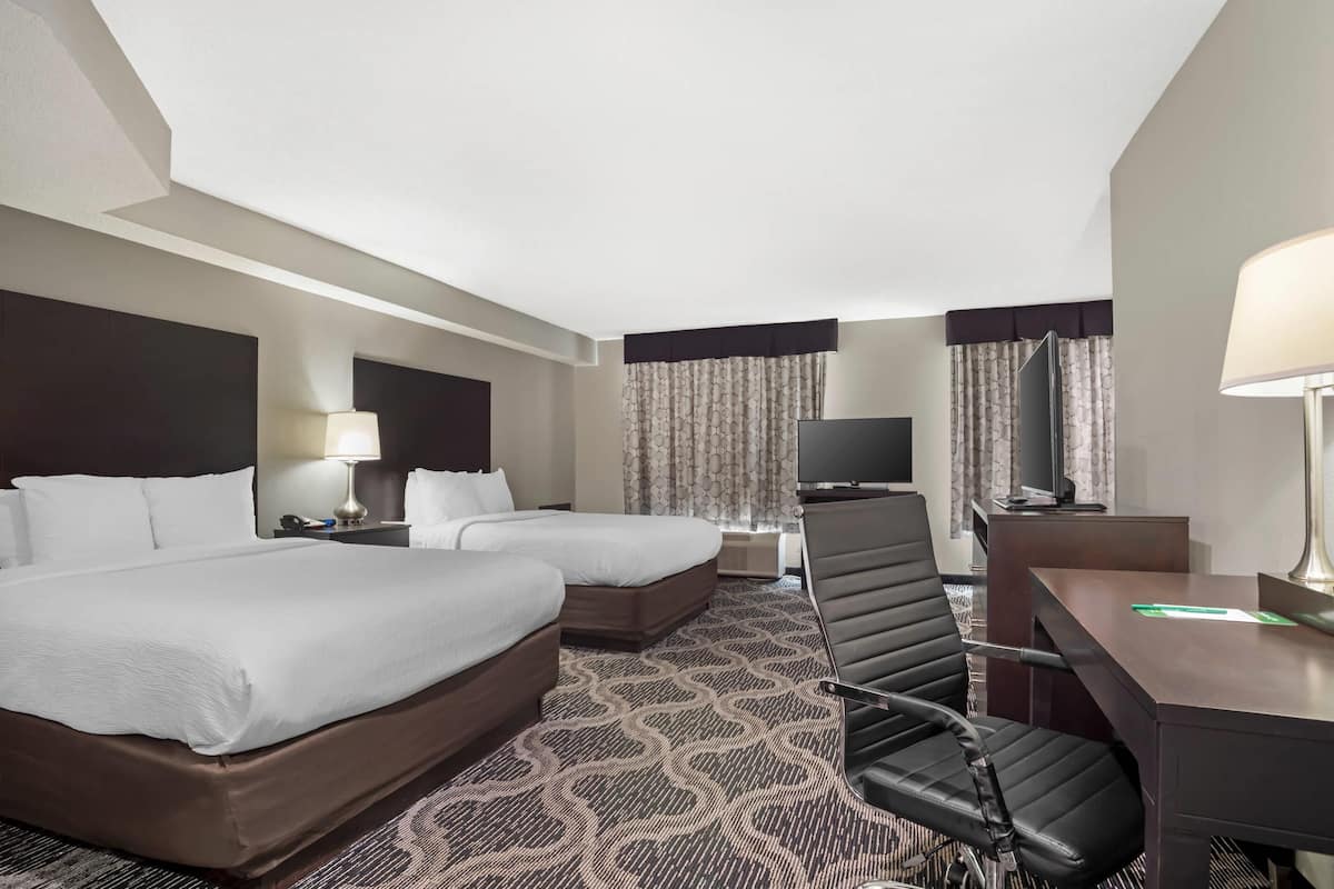 Suite, Multiple Beds, Non Smoking (2 Queen Beds, Sofa Bed) | Desk, laptop workspace, blackout drapes, iron/ironing board