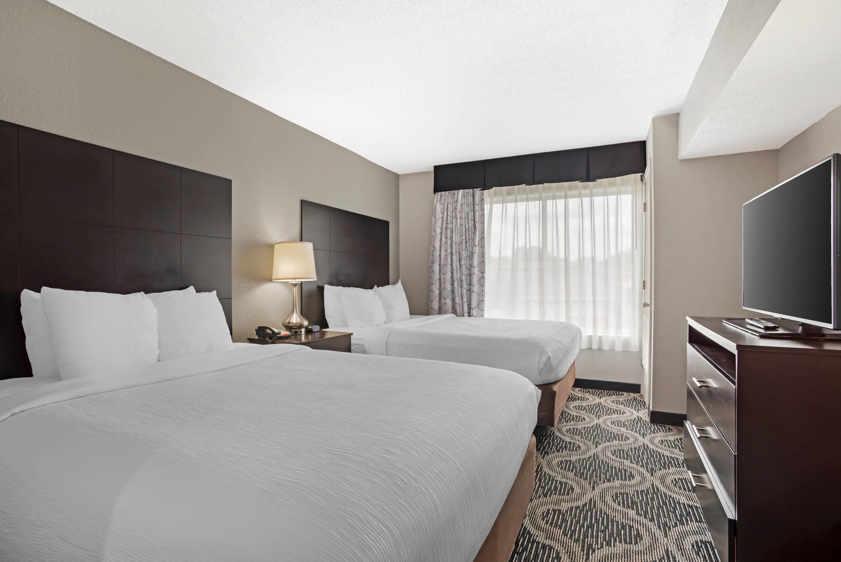 Suite, Non Smoking (2 Queen, 2 Person Sofabed) | Desk, laptop workspace, blackout drapes, iron/ironing board