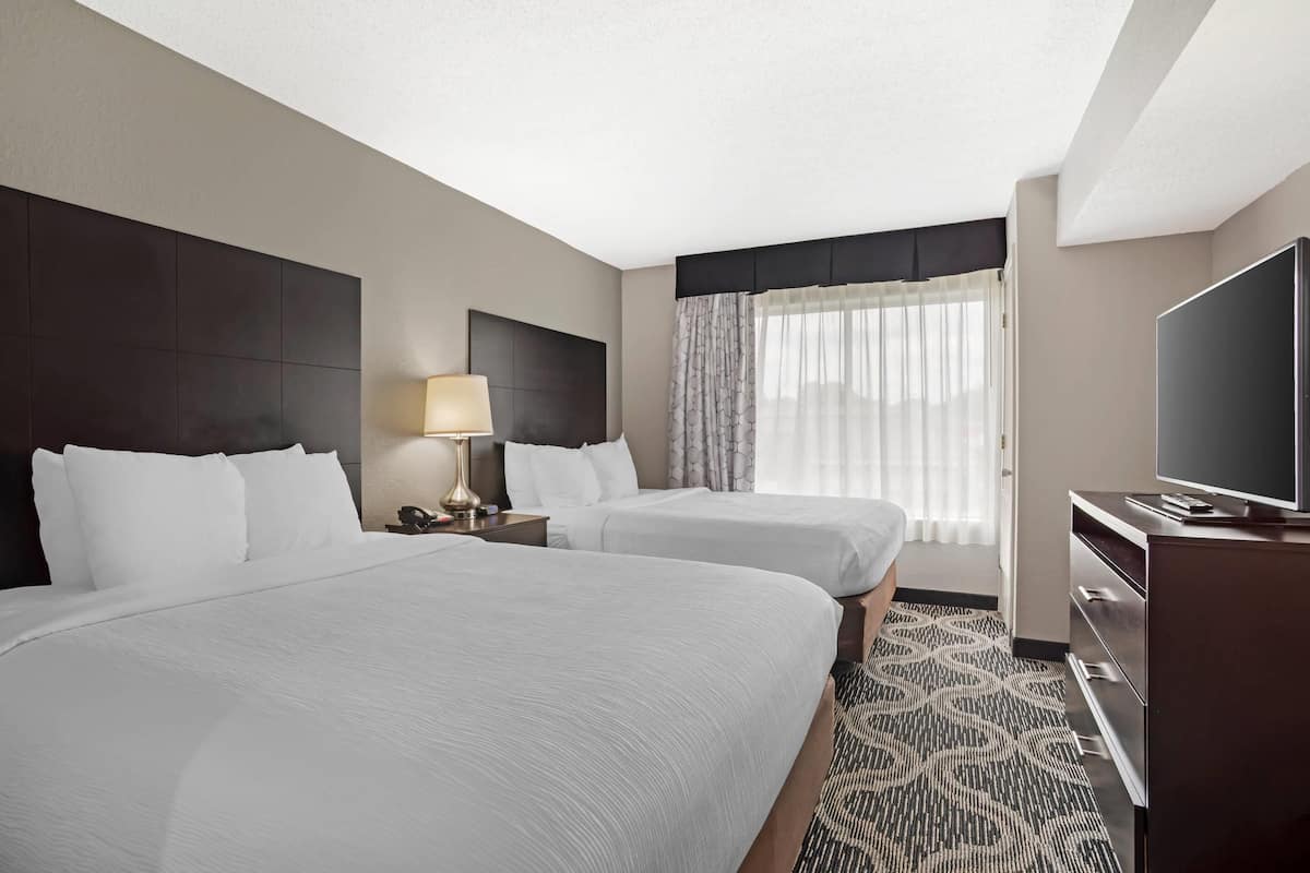 Suite, Non Smoking (2 Queen, 2 Person Sofabed) | Desk, laptop workspace, blackout drapes, iron/ironing board