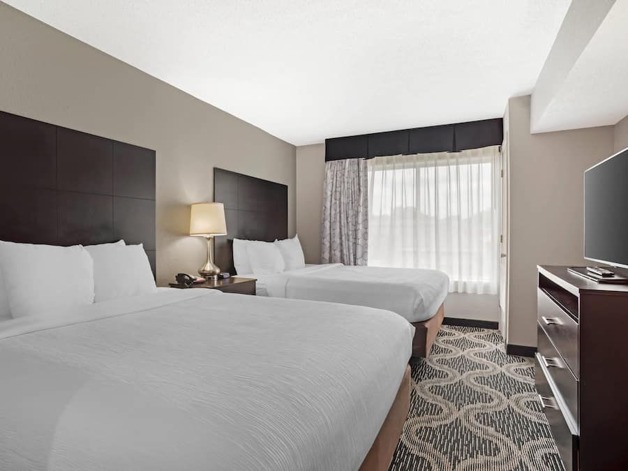 Suite, Non Smoking (2 Queen, 2 Person Sofabed) | Desk, laptop workspace, blackout curtains, iron/ironing board