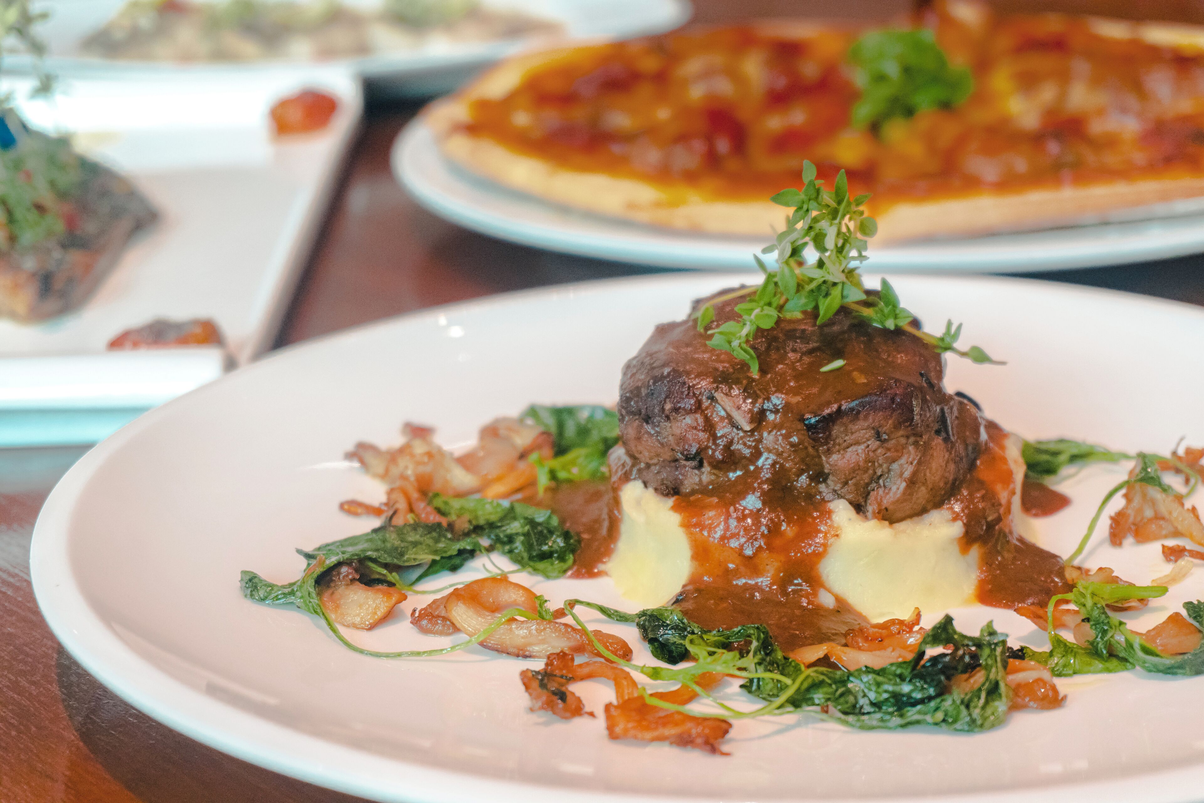 A plate of food with a steak and vegetables.