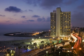 A high-rise hotel with a beach view, featuring a prominent Renaissance logo.