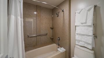 A bathroom with a bathtub, a shower, and a toilet.
