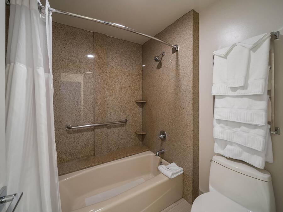 A bathroom with a bathtub, a shower, and a toilet.