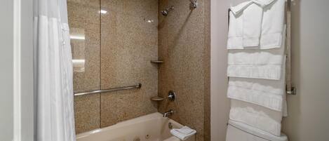 A bathroom with a bathtub, a shower, and a toilet.