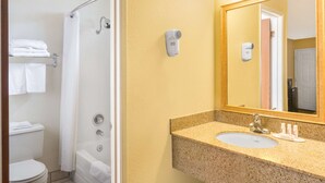 A bathroom with a shower, toilet, sink, and a mirror. - Super 8 by Wyndham Corning (Corning)