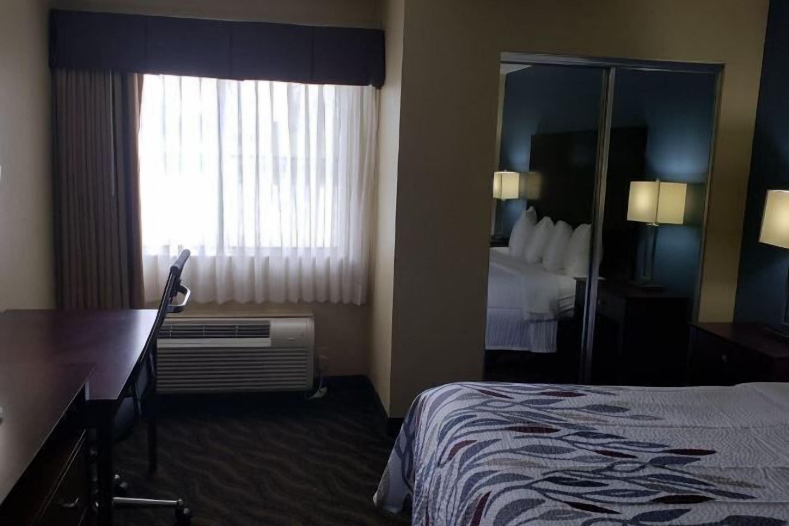 Desk, laptop workspace, blackout drapes, iron/ironing board