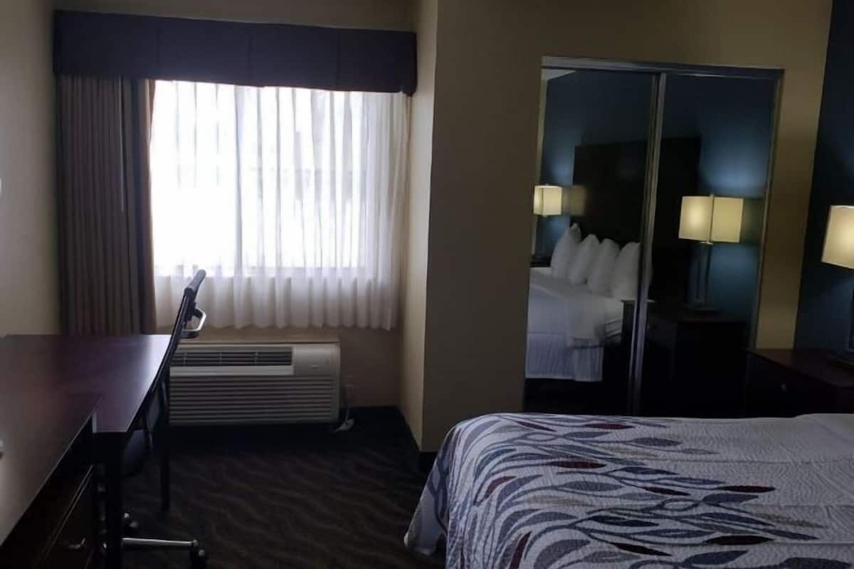 Desk, laptop workspace, blackout drapes, iron/ironing board