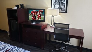 A hotel room with a TV, desk, chair, and a bed. - Red Roof Inn Port Allen West LSU Stadium (Port Allen)