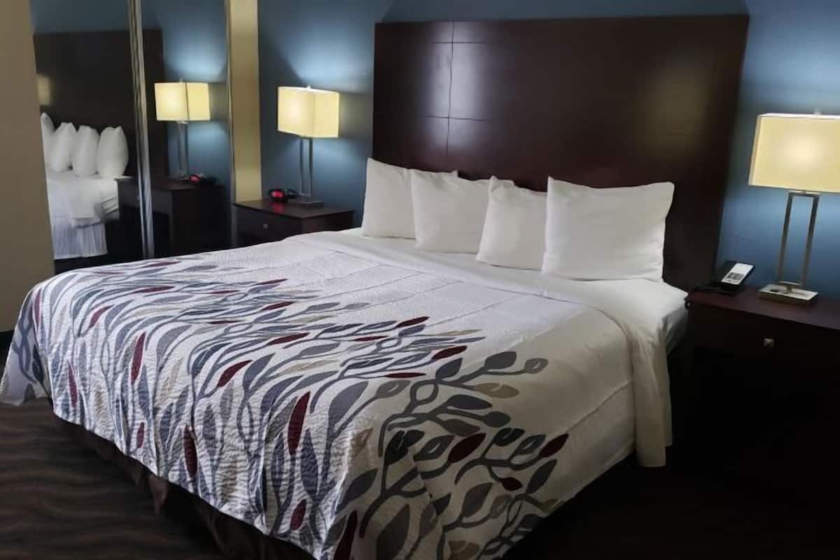 Desk, laptop workspace, blackout drapes, iron/ironing board