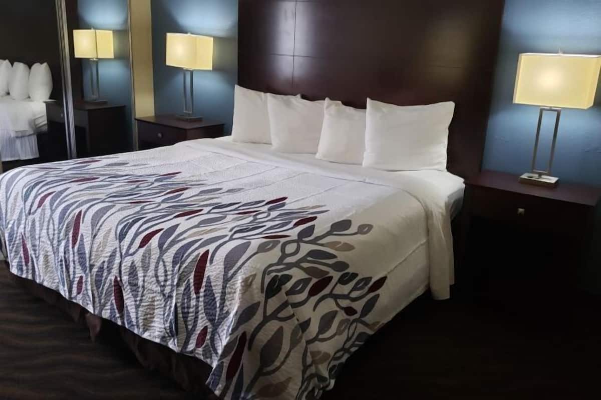 Desk, laptop workspace, blackout drapes, iron/ironing board