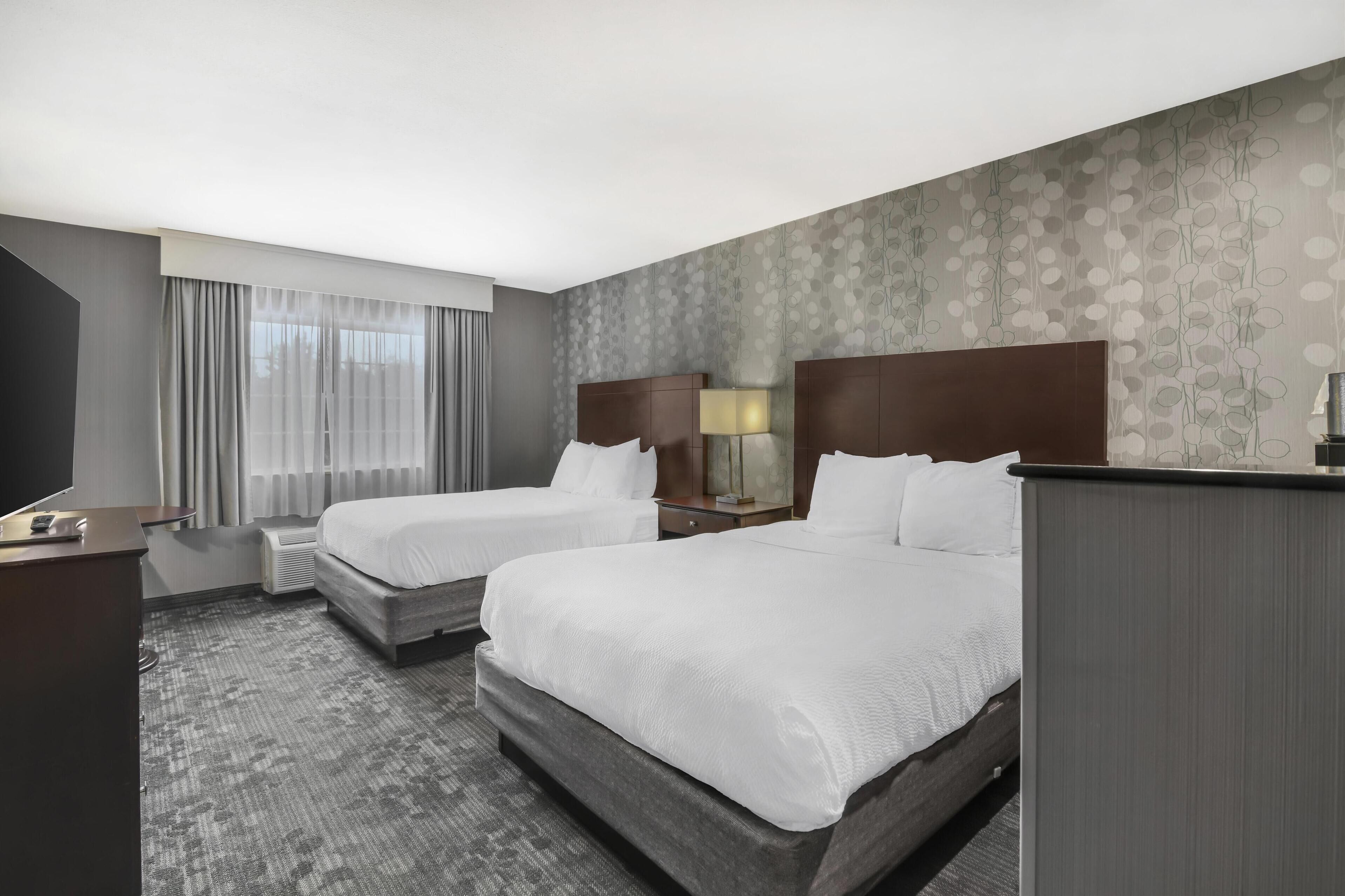 standard room, 2 queen beds, non smoking, refrigerator & microwave | in-room safe, blackout curtains, iron/ironing board