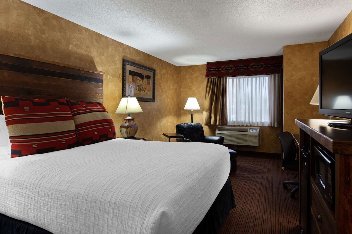 Desk, laptop workspace, blackout drapes, iron/ironing board