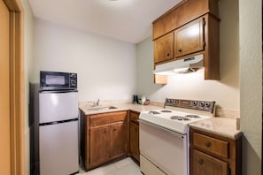 Fridge, microwave, coffee/tea maker, cookware/dishes/utensils