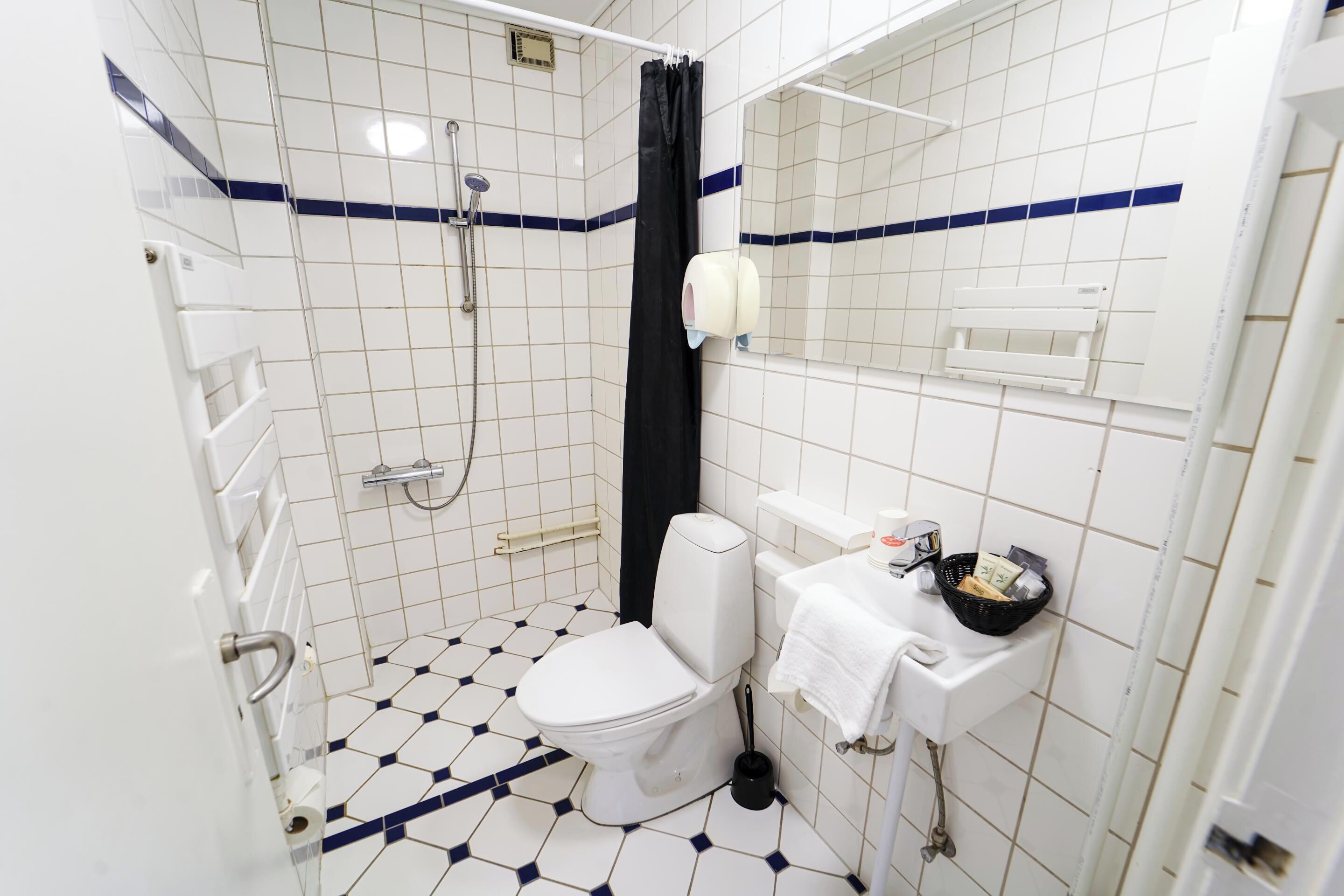 standard double room | bathroom | shower, eco-friendly toiletries, hair dryer, slippers