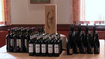 A table with multiple wine bottles arranged in rows.