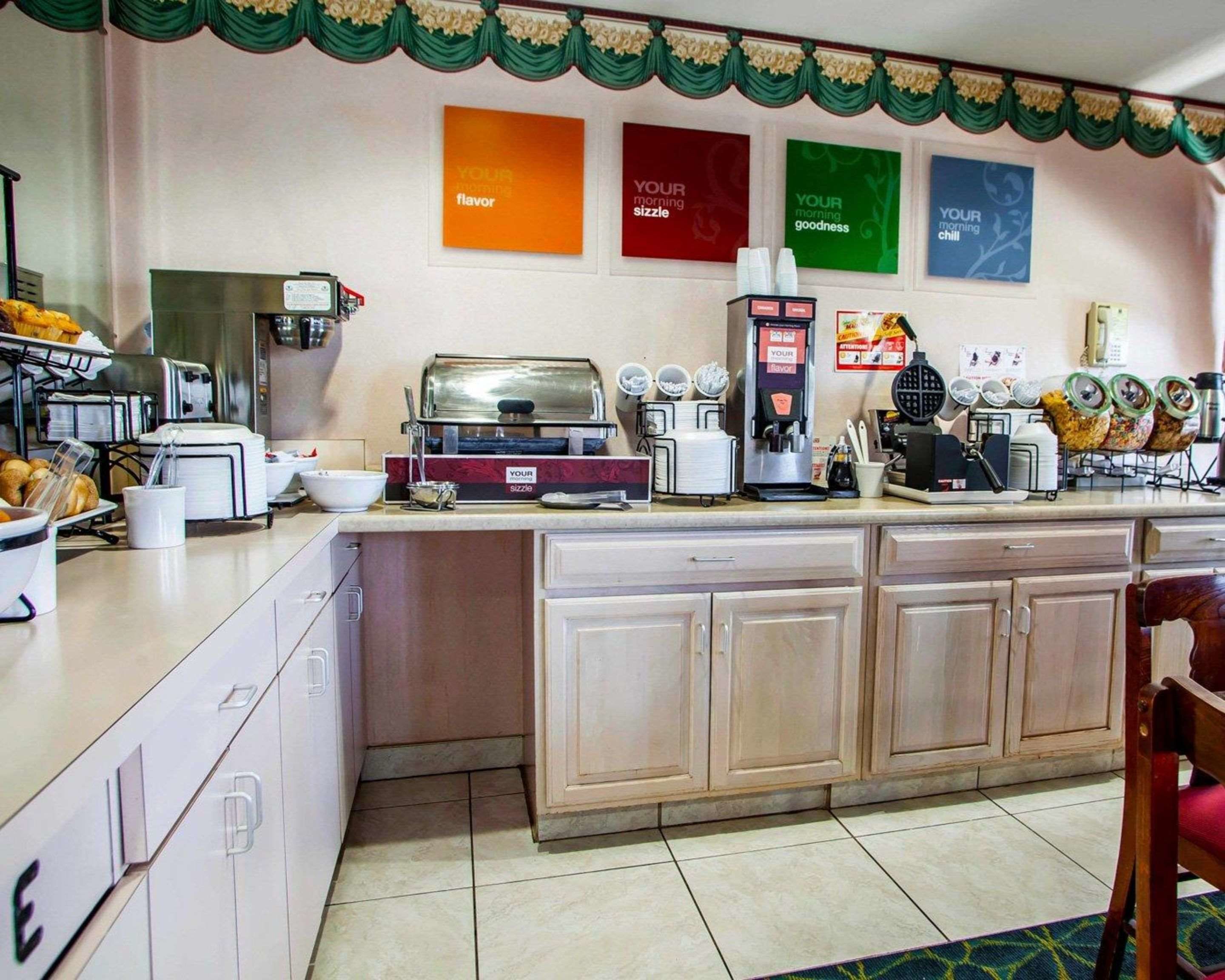 A kitchen area with a coffee machine, a waffle maker, and various food items on the counter.