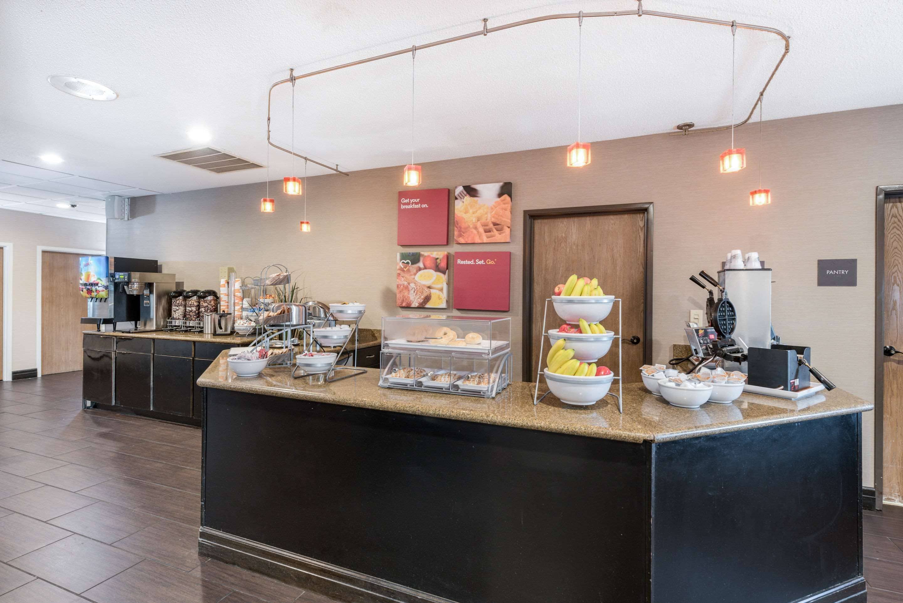 A breakfast bar with various food items and a coffee machine.