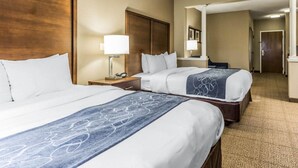 A hotel room with two beds, a nightstand with a lamp, a mirror, and a carpeted floor. - Comfort Suites at Isle Of Palms Connector (Mount Pleasant)