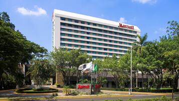 A Marriott hotel with a modern design, featuring a large building with multiple floors and a prominent 'Marriott' sign.