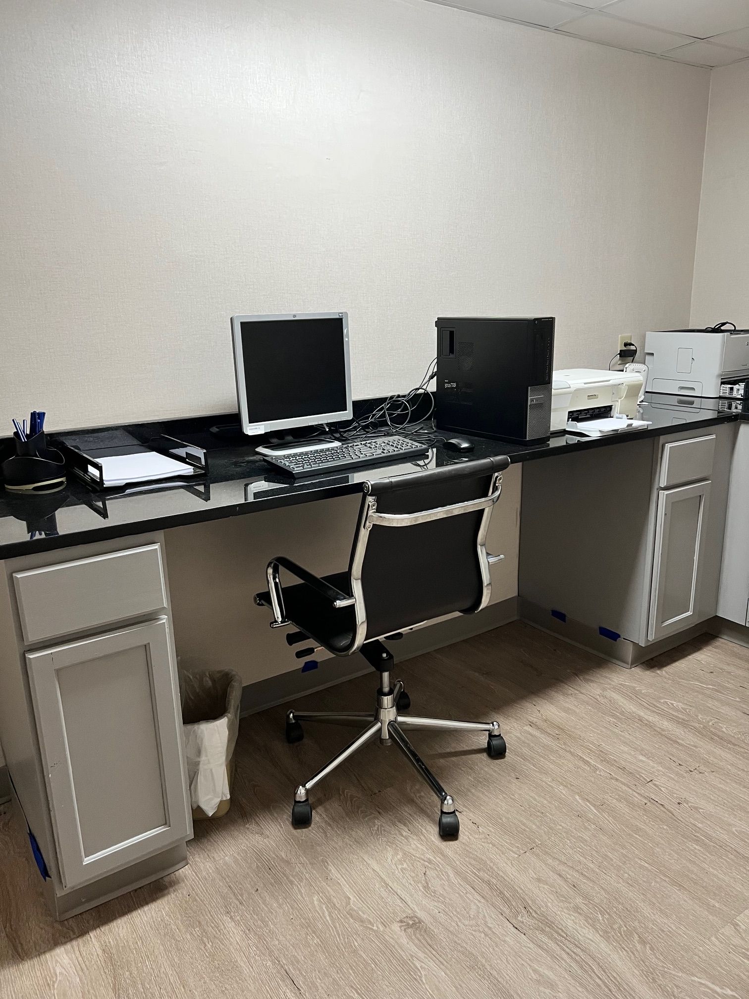 A modern office desk with a computer, keyboard, and mouse.