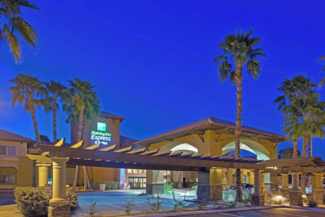 Un hôtel Holiday Inn Express doté d’une piscine, de palmiers et d’une entrée abritée.