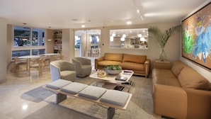 A modern living room with a sofa, armchairs, a coffee table, and a dining area with a table and chairs. - Best Western El Dorado Panama Hotel (Panama City)